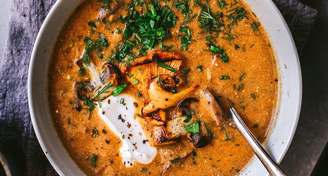 A bowl of hungarian mushroom soup with fresh dill.